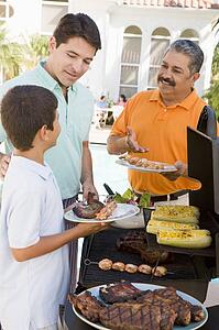 Family Enjoying A Barbeque