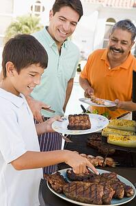 Family Enjoying A Barbeque