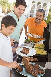 Family Enjoying A Barbeque