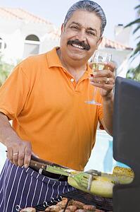 Man Barbequing In A Garden
