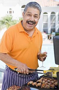 Man Barbequing In A Garden