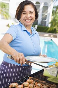 Woman Cooking On A Barbeque