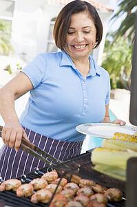Woman Cooking On A Barbeque