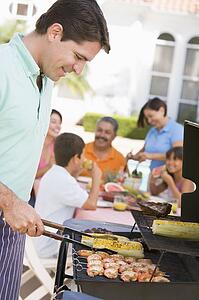 Family Enjoying A Barbeque