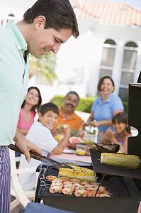 Family Enjoying A Barbeque