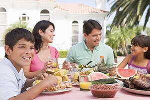 Family Enjoying A Barbeque