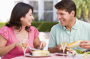 Couple Enjoying A Barbequed Meal In The Garden