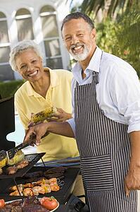 Couple Cooking On A Barbeque