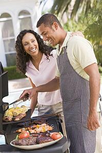 Couple Cooking On A Barbeque