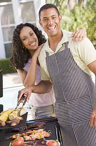 Couple Cooking On A Barbeque