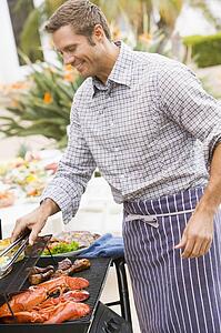 Man Barbequing In A Garden