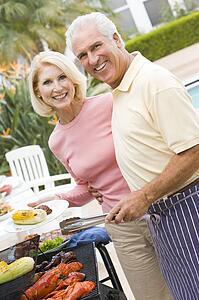 Couple Cooking On A Barbeque