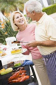 Couple Cooking On A Barbeque