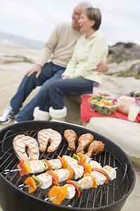 Couple Cooking On A Barbeque