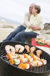 Couple Cooking On A Barbeque