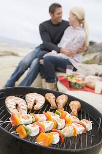 Couple Cooking On A Barbeque