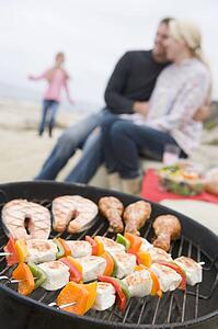 Couple Cooking On A Barbeque