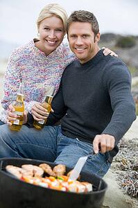 Couple Cooking On A Barbeque