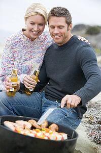 Couple Cooking On A Barbeque