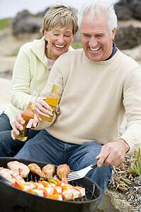 Couple Cooking On A Barbeque