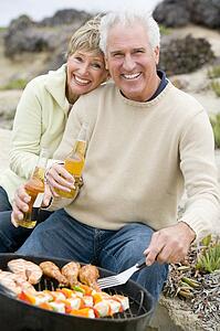 Couple Cooking On A Barbeque