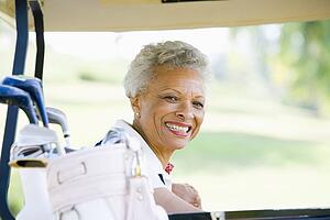Portrait Of Woman Sitting In A Golf Cart