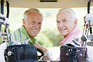 Male Friends Enjoying A Game Of Golf