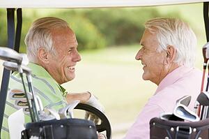 Male Friends Enjoying A Game Of Golf