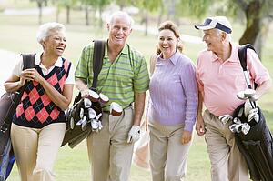 Portrait Of Four Friends Enjoying A Game Golf