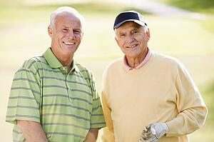 Male Friends Enjoying A Game Of Golf