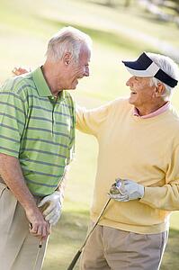 Male Friends Enjoying A Game Of Golf