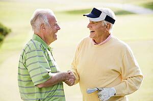 Male Friends Enjoying A Game Of Golf