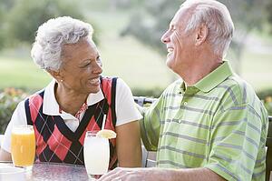 Couple Enjoying A Beverage By A Golf Course