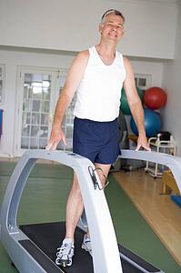Man Running On Treadmill At Gym