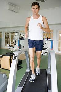 Man Running On Treadmill At Gym