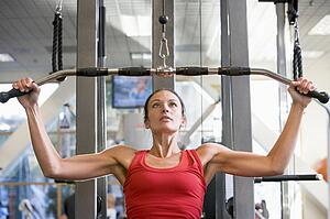 Woman Weight Training At Gym