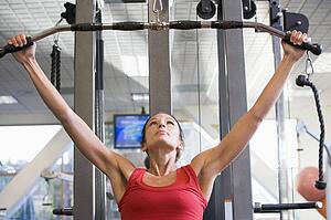 Woman Weight Training At Gym