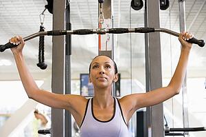 Woman Weight Training At Gym