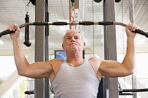 Man Weight Training At Gym