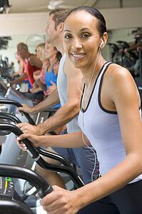 Woman Running On Treadmill At Gym