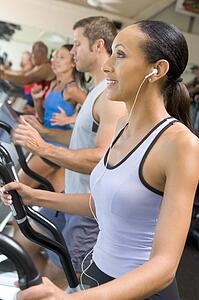 Woman Running On Treadmill At Gym