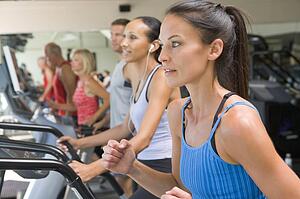 Woman Running On Treadmill At Gym