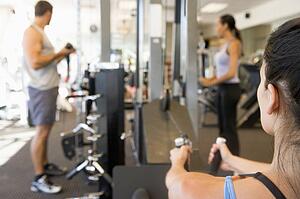 Group Of People Weight Training At Gym