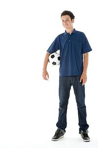 Portrait Of Teenage Boy With A Soccer Ball