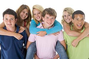 Teenage Girls Piggy Back On Boys