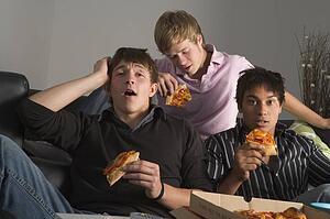 Teenage Boys Eating Pizza