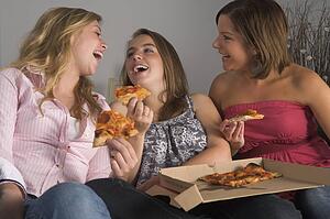 Teenage Girls Eating Pizza