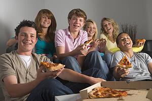 Teenagers Having Fun And Eating Pizza