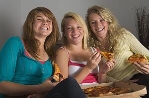 Teenage Girls Eating Pizza