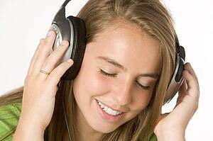 Teenage Girl Listening To Music On Headphones